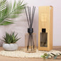 Reed diffuser set with English pear and freesia scent, in a modern home décor setting with plants.