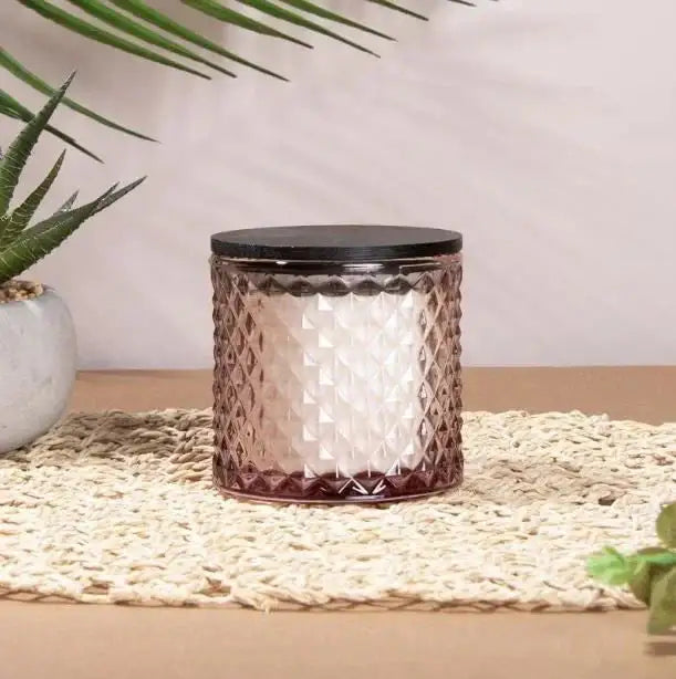 Textured glass candle jar with black lid on woven mat, home decor gift idea