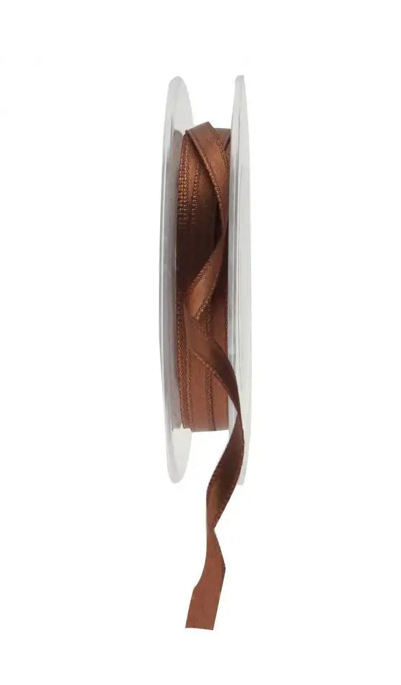 Rich brown satin ribbon on spool for luxury gift wrapping and home décor accents