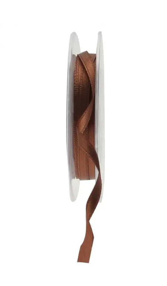 Rich brown satin ribbon on spool for luxury gift wrapping and home décor accents