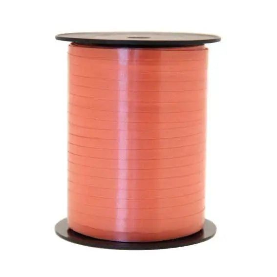 Coral satin ribbon spool for gift wrapping and home décor accents