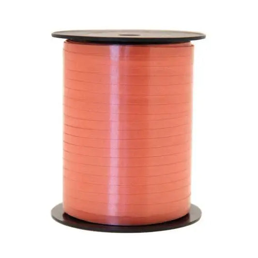 Coral satin ribbon spool for gift wrapping and home décor accents