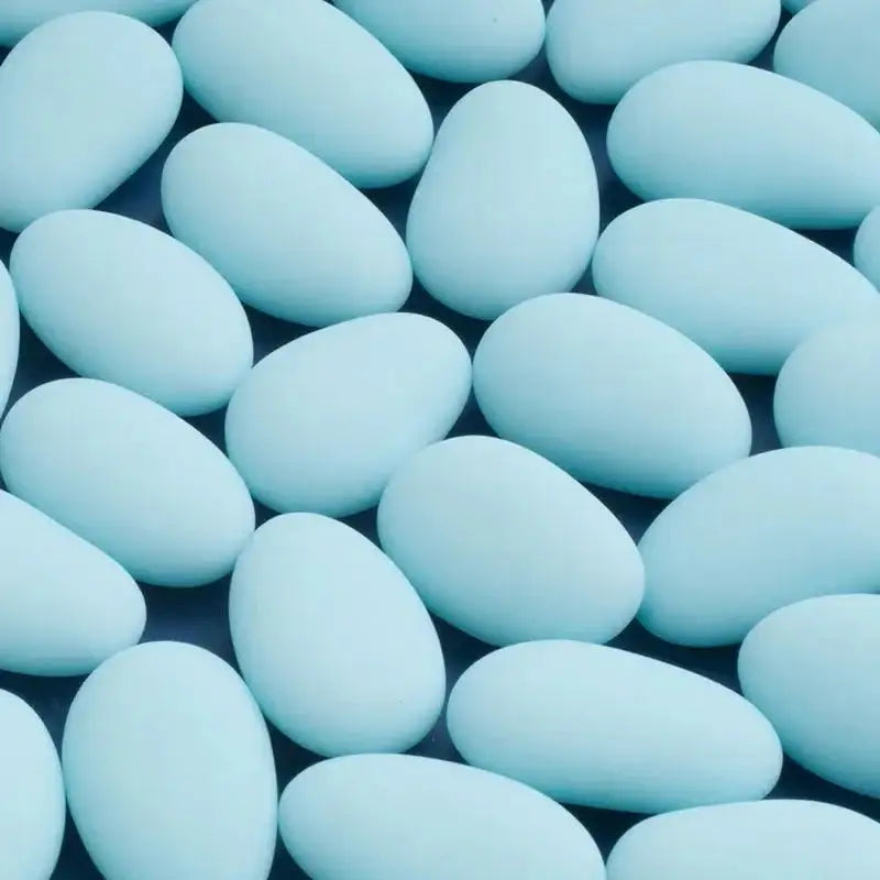 Scattered light blue candy-coated almonds for celebrations or wedding favors
