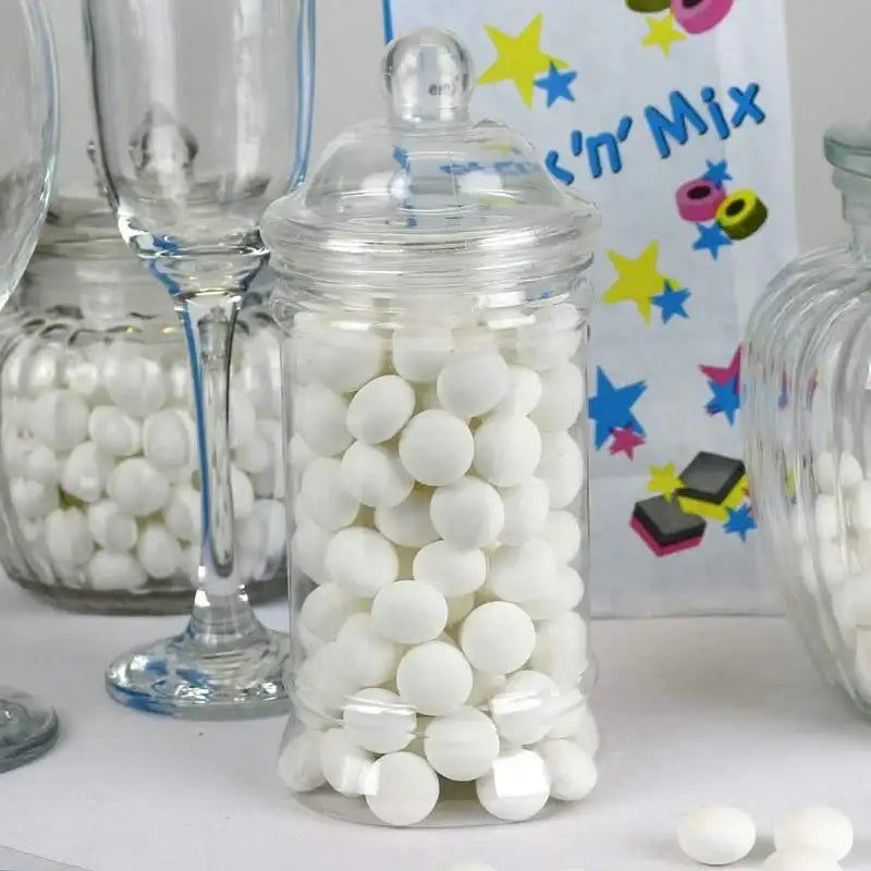 Glass jar filled with white candy sweets on a party table with pick 'n' mix decor
