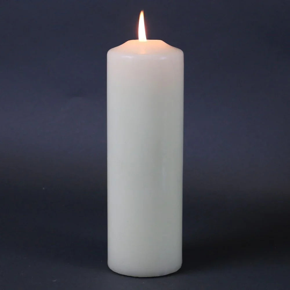 Lit white pillar candle for home décor and celebration ambiance