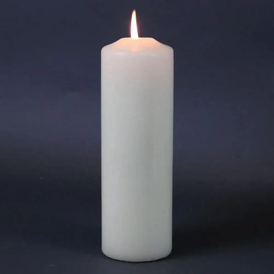Lit white pillar candle for home décor and celebration ambiance