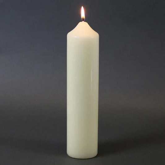 Lit white pillar candle for home décor and celebrations, creating warm ambiance