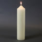 Lit white pillar candle for home décor and celebrations, creating warm ambiance