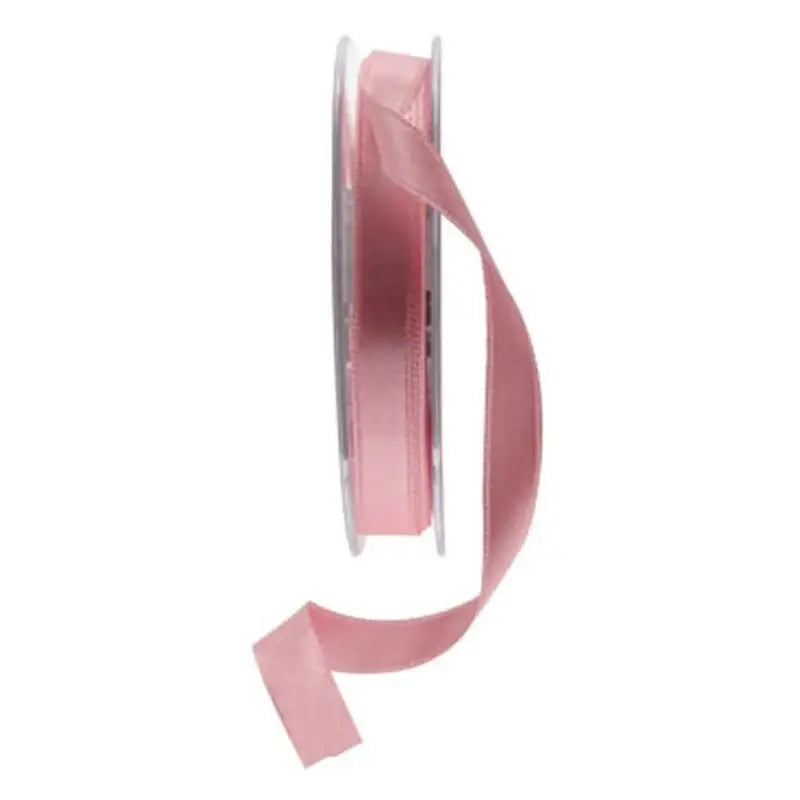 Soft pink satin ribbon spool for gift wrapping and home décor accents