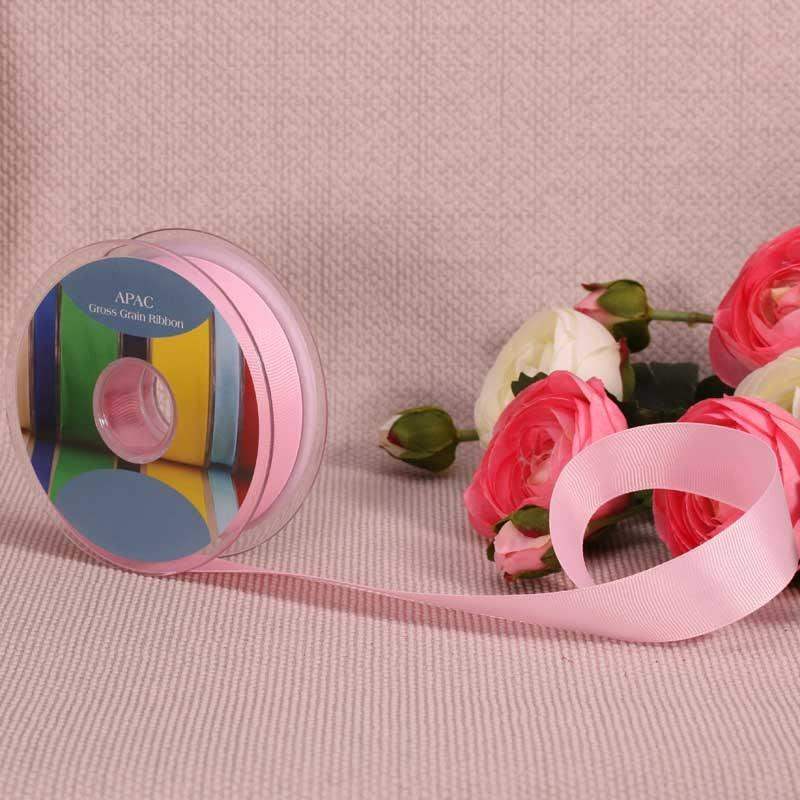 Pink grosgrain ribbon spool with roses, perfect for luxury gift wrapping and home décor accents