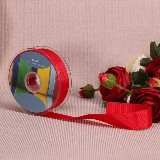 Red grosgrain ribbon spool with roses, perfect for luxury gift wrapping and home décor accents